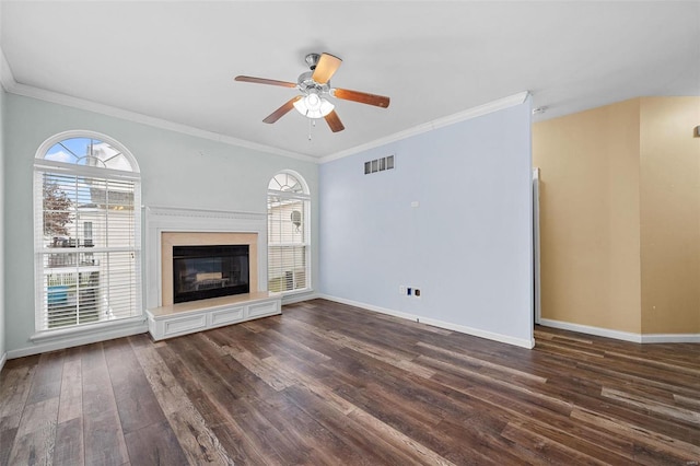 unfurnished living room featuring crown molding, a high end fireplace, ceiling fan, and dark hardwood / wood-style flooring