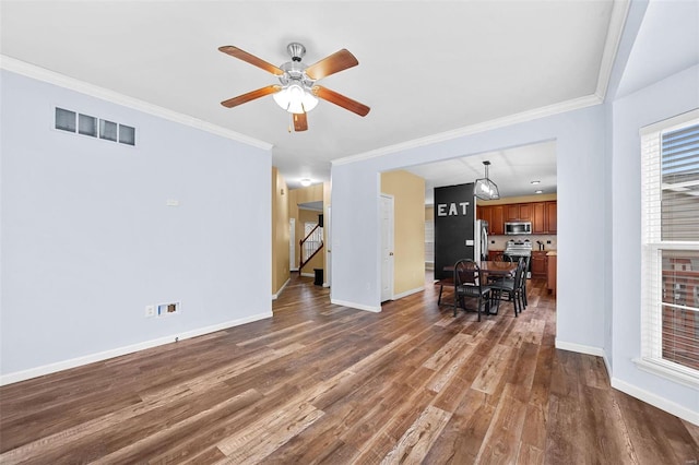 unfurnished living room featuring ornamental molding, dark hardwood / wood-style floors, and ceiling fan