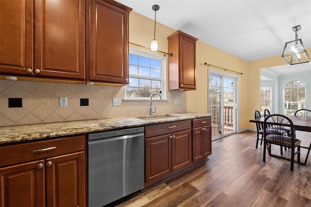 kitchen featuring sink, decorative light fixtures, dark hardwood / wood-style floors, dishwasher, and decorative backsplash