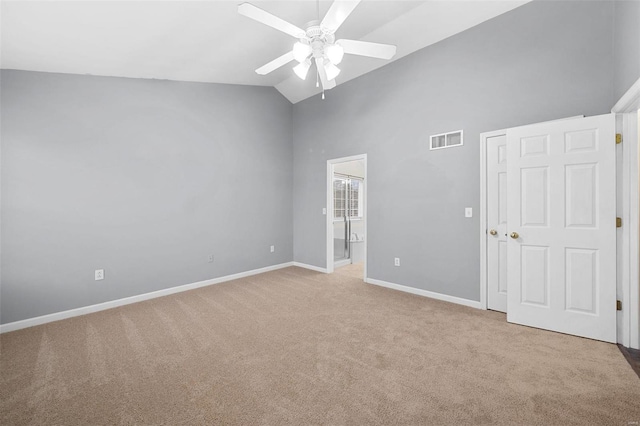 carpeted spare room with ceiling fan and lofted ceiling