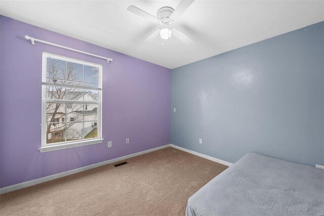 carpeted bedroom featuring ceiling fan