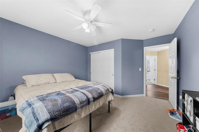 carpeted bedroom with ceiling fan and a closet