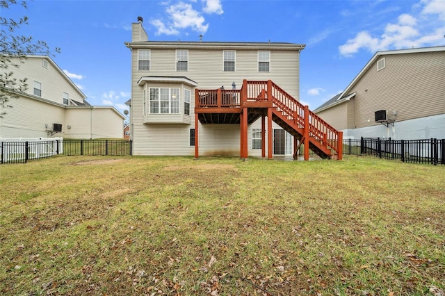 rear view of property with a lawn and a deck