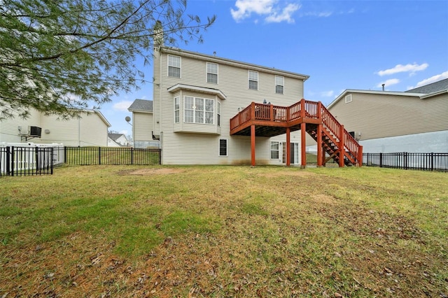 rear view of property with a wooden deck and a lawn