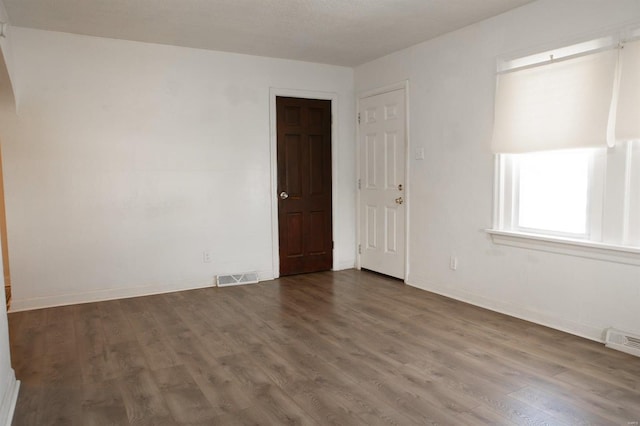 unfurnished room with hardwood / wood-style floors