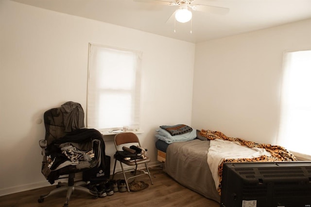 bedroom with ceiling fan and dark hardwood / wood-style flooring