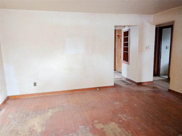 unfurnished room featuring hardwood / wood-style flooring