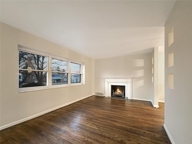 unfurnished living room featuring dark wood-type flooring