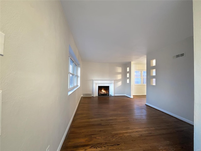 unfurnished living room with dark hardwood / wood-style floors