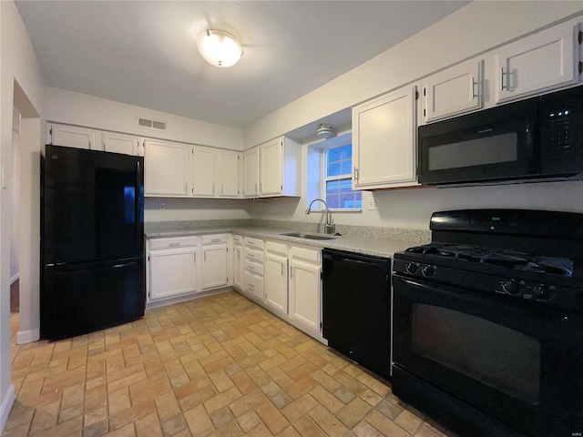 kitchen with white cabinetry, sink, and black appliances