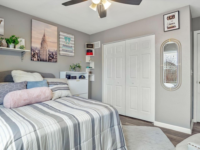 bedroom featuring ceiling fan, dark hardwood / wood-style flooring, and a closet