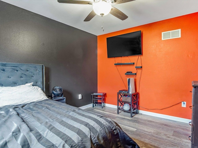 bedroom with hardwood / wood-style floors and ceiling fan