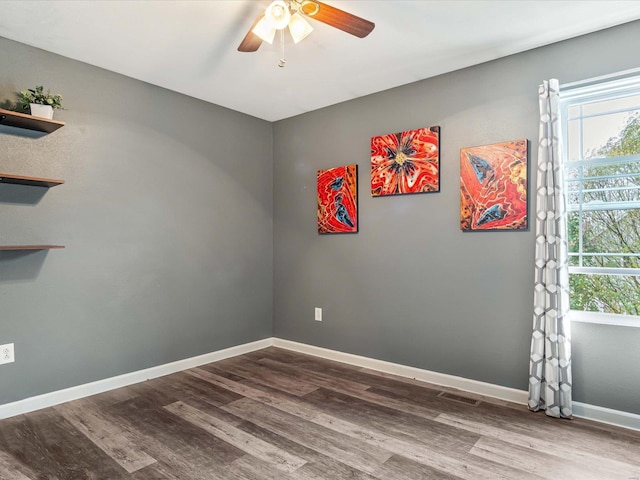 spare room featuring ceiling fan, hardwood / wood-style flooring, and a healthy amount of sunlight