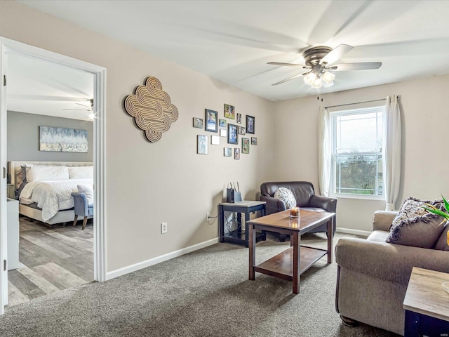 carpeted living room with ceiling fan