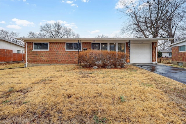 single story home featuring a garage and a front yard