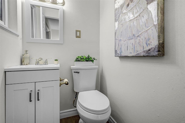 bathroom with vanity, wood-type flooring, and toilet