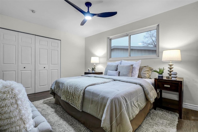 bedroom with a closet, dark hardwood / wood-style floors, and ceiling fan