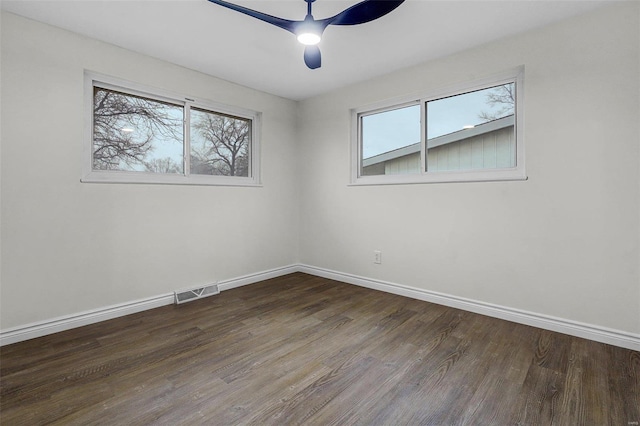 unfurnished room with dark wood-type flooring and ceiling fan