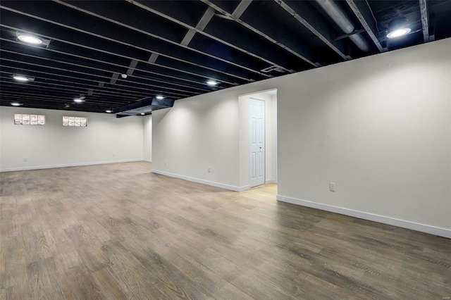 basement with hardwood / wood-style flooring