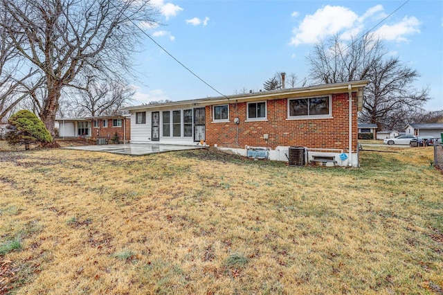 rear view of property with a yard and a patio