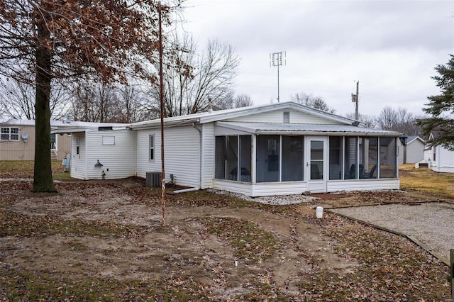 back of house featuring cooling unit and a sunroom