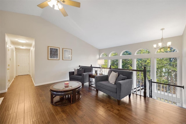 living room featuring hardwood / wood-style flooring, ceiling fan with notable chandelier, and high vaulted ceiling