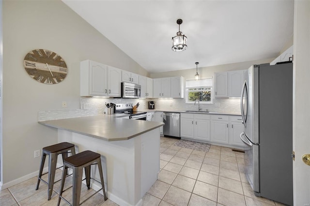 kitchen with white cabinetry, appliances with stainless steel finishes, sink, and pendant lighting