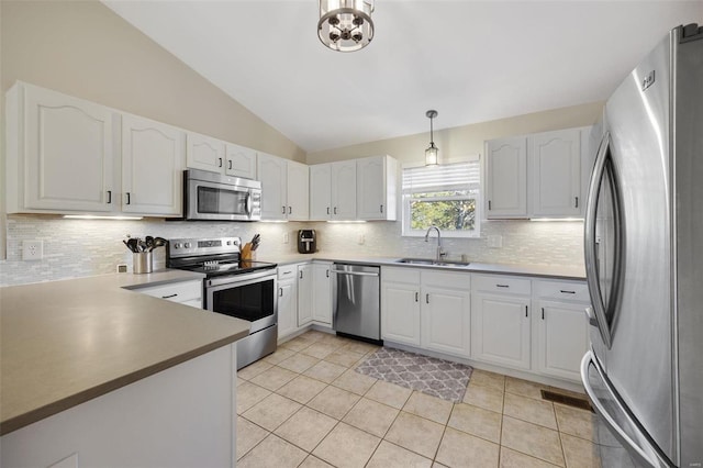 kitchen with pendant lighting, white cabinets, and appliances with stainless steel finishes