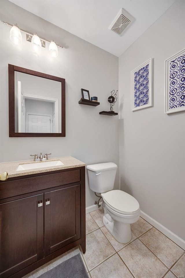 bathroom featuring vanity, toilet, and tile patterned flooring