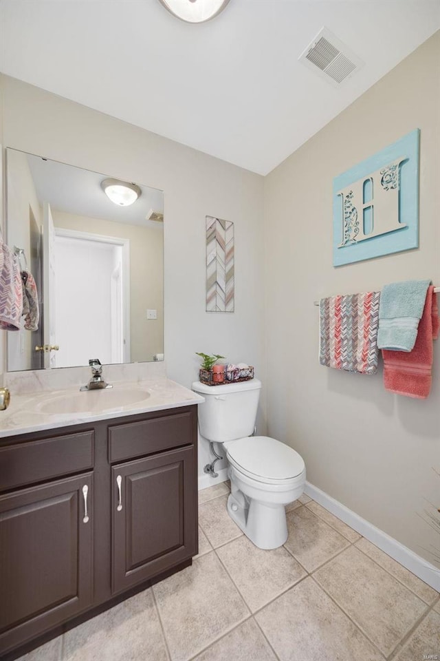 bathroom featuring tile patterned flooring, vanity, and toilet