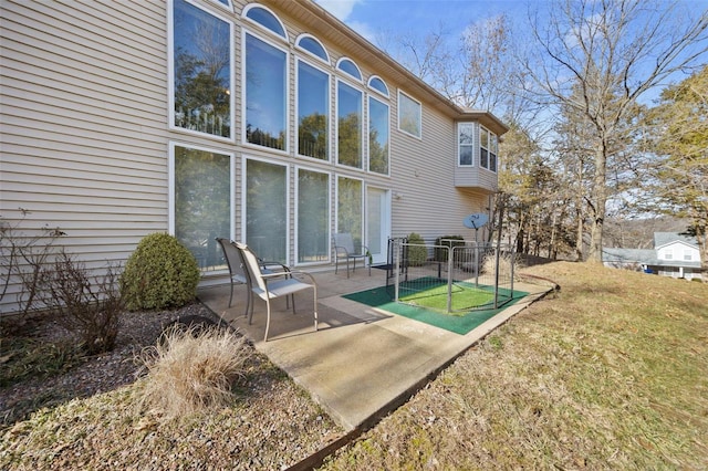 rear view of house with a patio area and a lawn