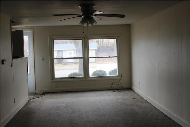 carpeted spare room with ceiling fan