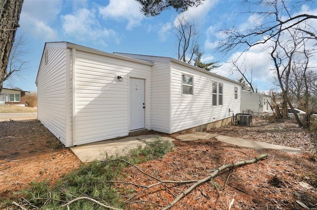 back of house featuring cooling unit