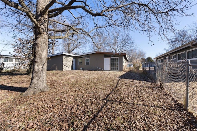 view of home's exterior featuring stucco siding and fence