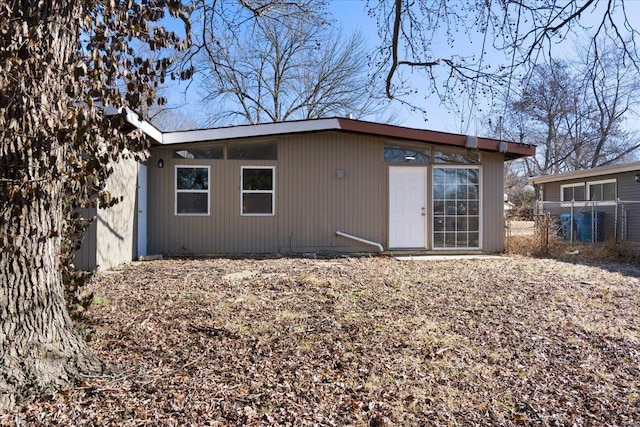 back of house featuring fence