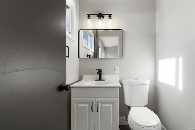 half bath with vanity and toilet