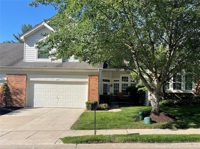 obstructed view of property with a garage and a front lawn