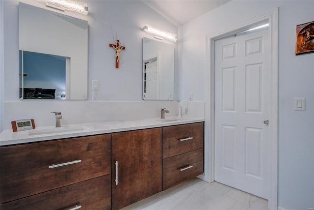 bathroom with vanity and vaulted ceiling