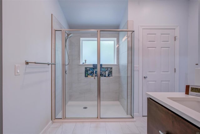 bathroom with a shower with door and vanity