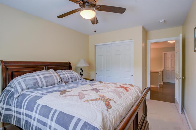 bedroom with light carpet, a closet, and ceiling fan