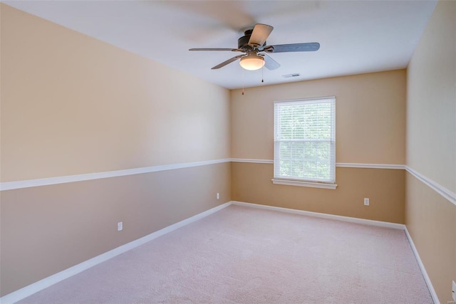 carpeted spare room with ceiling fan