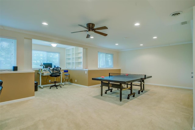 rec room featuring crown molding, light colored carpet, and ceiling fan