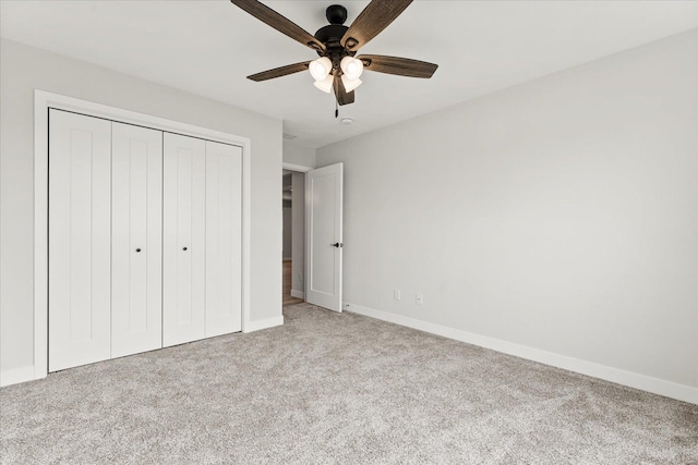 unfurnished bedroom with a ceiling fan, carpet, a closet, and baseboards