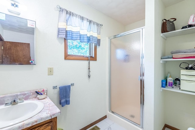 bathroom with vanity and a shower with shower door