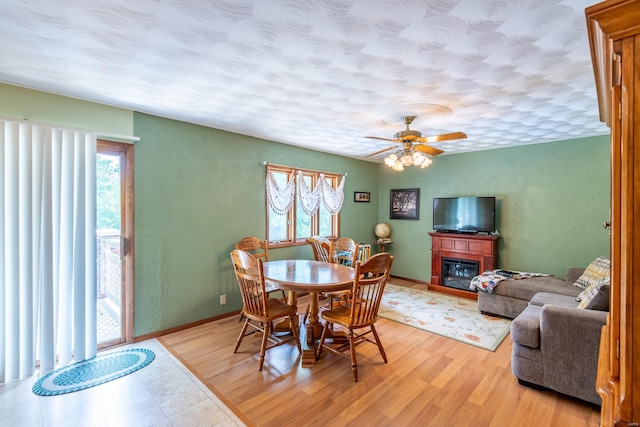 dining space with ceiling fan, light hardwood / wood-style flooring, and a healthy amount of sunlight