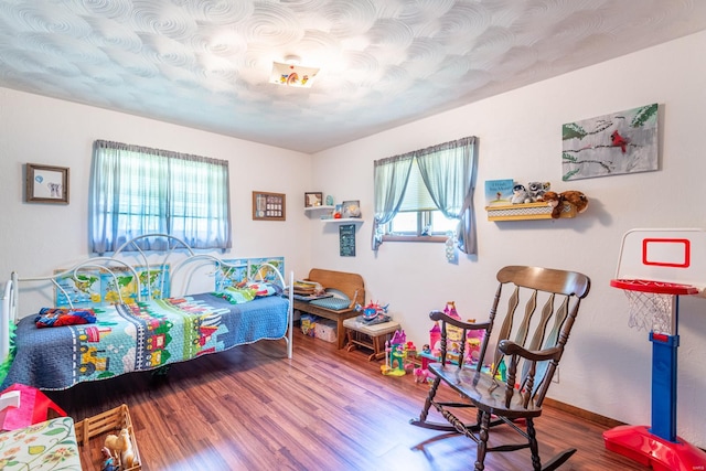 bedroom with wood-type flooring