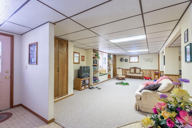 playroom with a paneled ceiling and light colored carpet