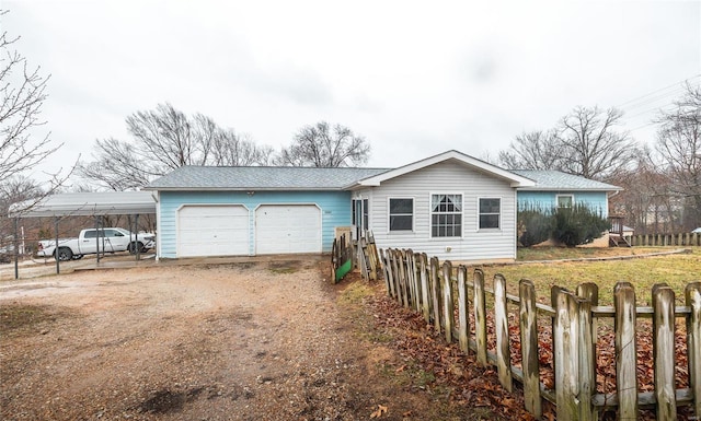 single story home featuring a garage, driveway, and fence