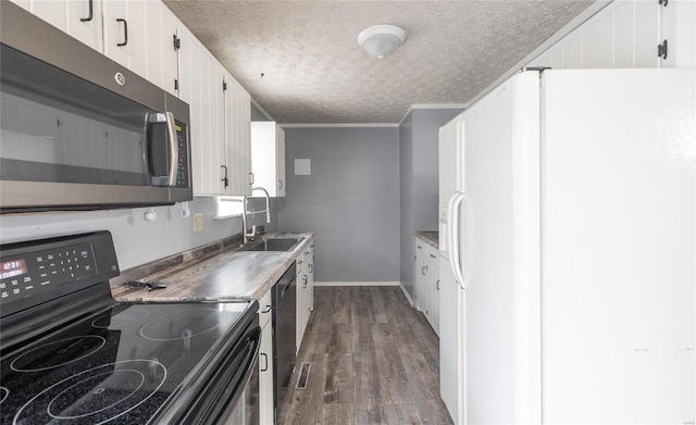 kitchen featuring white refrigerator with ice dispenser, dark wood-style floors, stainless steel microwave, black range with electric cooktop, and a sink