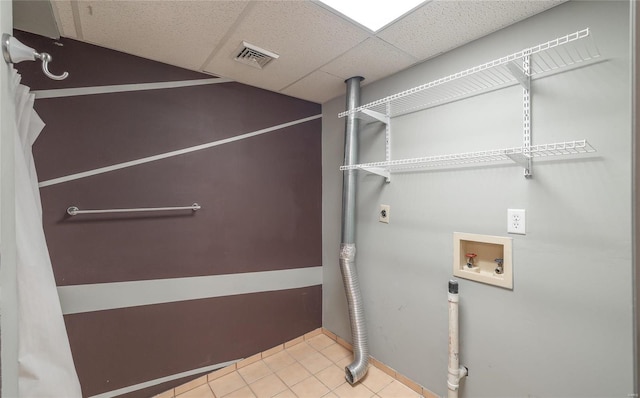 laundry area with tile patterned flooring, hookup for an electric dryer, laundry area, washer hookup, and visible vents